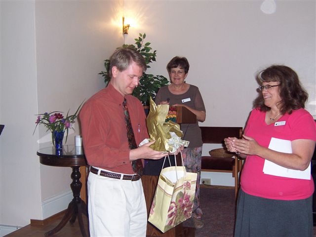 Rev. Joe receiving farewell gift.